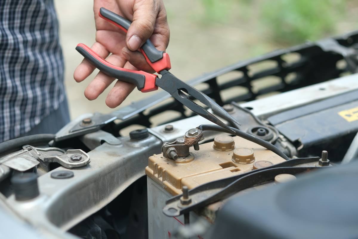 Testing a car battery terminal as part of an electrical diagnostic